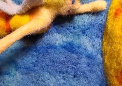 To start, use a mid-tone blue to lay in larger, loosely felted wavy lines.
