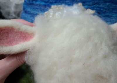 attaching a sheep ear when needle felting, lesson still image 2
