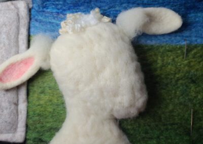 attaching a sheep ear when needle felting, lesson still image